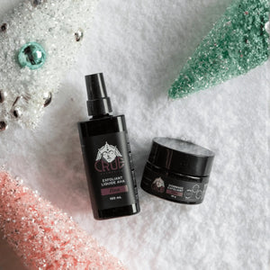 Crue cosmetics bottle and jar on a cotton surface.