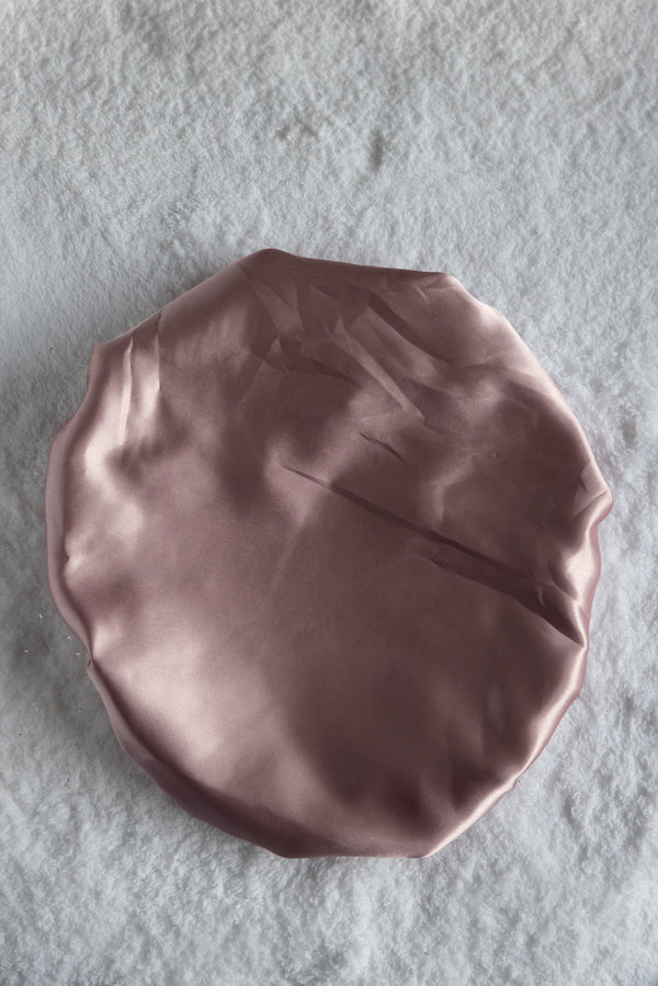 Crue rose color hair net top on a white surface