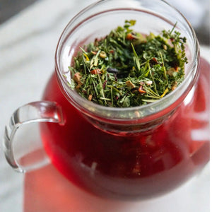 Crue cosmetics red tea leaves in a round glass jar