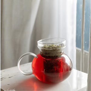 Crue cosmetics red tea leaves in a glass jar.